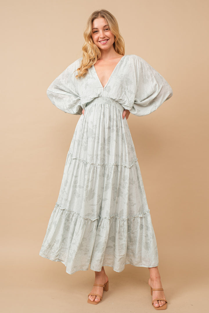 Jacquard Floral Dolman Maxi Dress with V-neck, tiered ruffle details, and tie tassel back, made from luxurious rayon fabric.